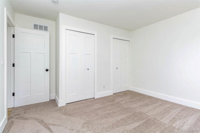 47387 Royal Rd, Macomb, MI 48044 - unfurnished bedroom featuring carpet flooring and two closets