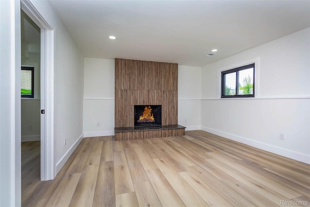 47387 Royal Rd, Macomb, MI 48044 - unfurnished living room with light wood-style floors, a large fireplace, and recessed lighting