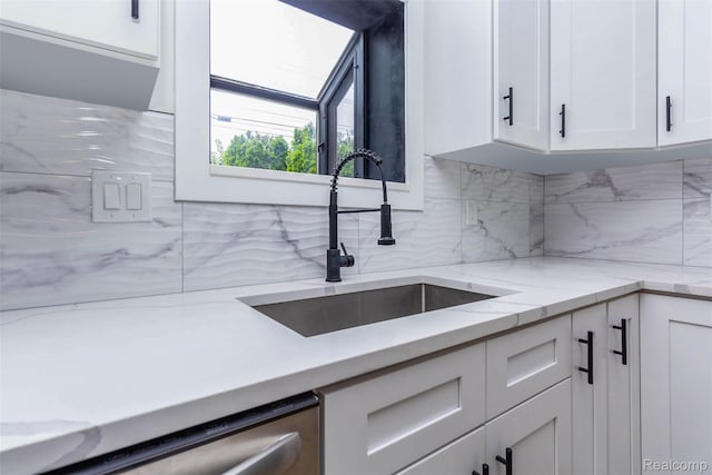47387 Royal Rd, Macomb, MI 48044 - kitchen with white cabinetry, decorative backsplash, stainless steel dishwasher, and light stone counters