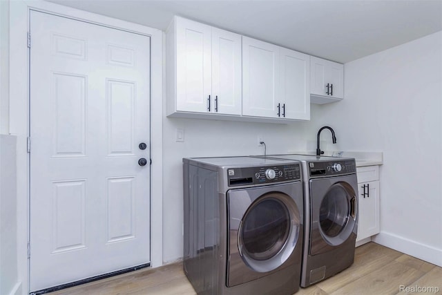 47387 Royal Rd, Macomb, MI 48044 - laundry room featuring washing machine and clothes dryer, light wood finished floors, and cabinet space