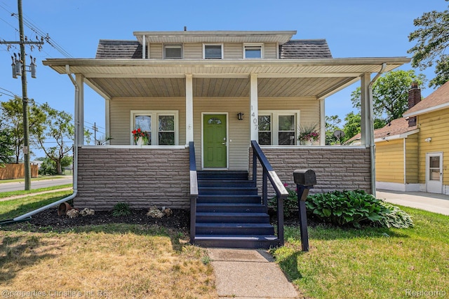 1407 W Marshall St, Ferndale, MI 48220 - view of front of home featuring covered porch, stone siding, a shingled roof, and a front yard