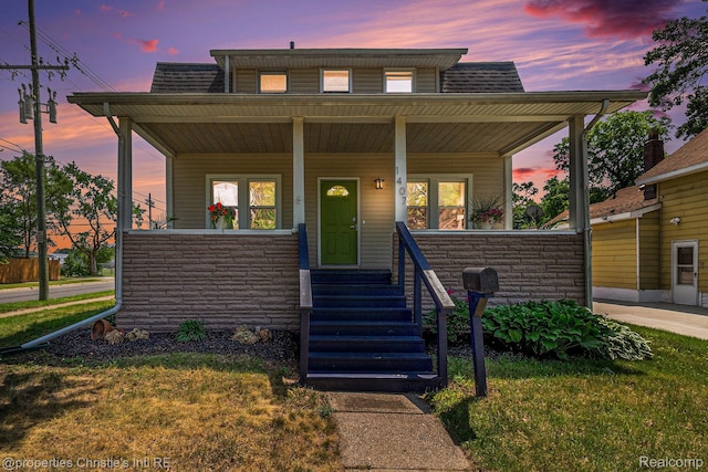 1407 W Marshall St, Ferndale, MI 48220 - bungalow-style house featuring covered porch, stone siding, and a front yard
