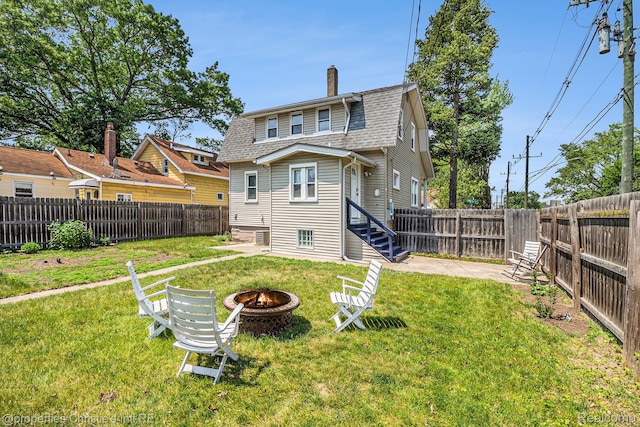 1407 W Marshall St, Ferndale, MI 48220 - back of property with an outdoor fire pit, a chimney, roof with shingles, and a fenced backyard