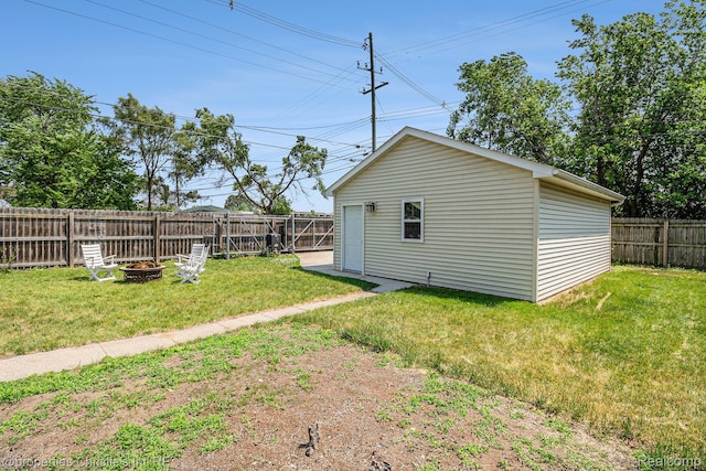 1407 W Marshall St, Ferndale, MI 48220 - fenced backyard featuring a fire pit and an outbuilding