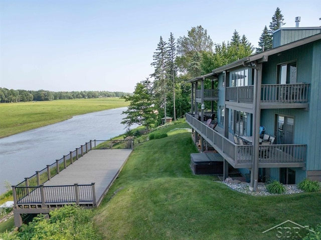 4394 N Francis Shores Ave, Sanford, MI 48657 - view of community with a lawn and a water view