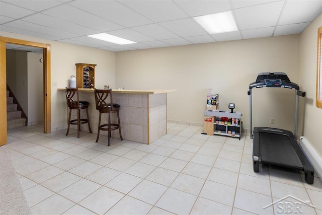4394 N Francis Shores Ave, Sanford, MI 48657 - indoor dry bar featuring a paneled ceiling, stairs, and light tile patterned floors