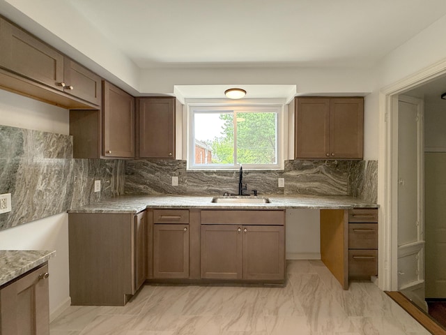 5016 E Outer Dr, Detroit, MI 48234 - kitchen with backsplash, light marble finish flooring, and light stone countertops