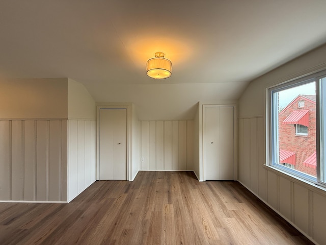5016 E Outer Dr, Detroit, MI 48234 - additional living space with wood finished floors, a decorative wall, and lofted ceiling