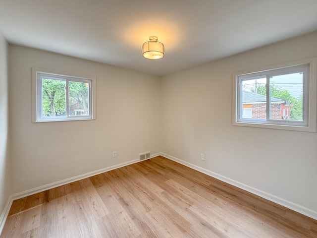 5016 E Outer Dr, Detroit, MI 48234 - empty room featuring healthy amount of natural light and light wood finished floors