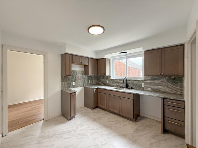5016 E Outer Dr, Detroit, MI 48234 - kitchen featuring light marble finish flooring and tasteful backsplash