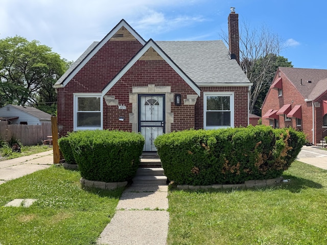 5016 E Outer Dr, Detroit, MI 48234 - view of front of home featuring brick siding, a chimney, and roof with shingles