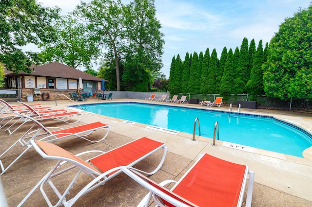 8597 Mathias Dr Unit 42, Grosse Ile, MI 48138 - community pool with a patio area