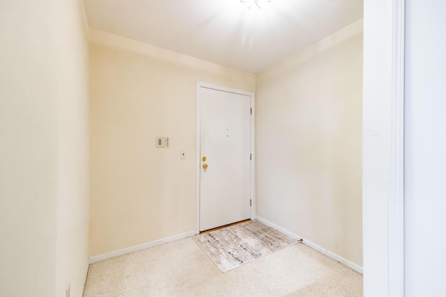 8597 Mathias Dr Unit 42, Grosse Ile, MI 48138 - foyer entrance featuring light carpet and baseboards