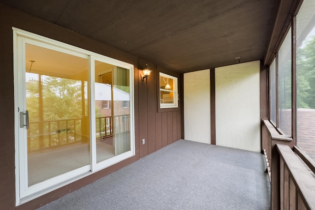 8597 Mathias Dr Unit 42, Grosse Ile, MI 48138 - unfurnished sunroom featuring healthy amount of natural light and carpet floors