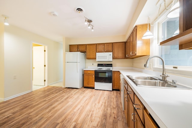 8597 Mathias Dr Unit 42, Grosse Ile, MI 48138 - kitchen featuring white appliances, brown cabinetry, light wood-style floors, light countertops, and decorative light fixtures