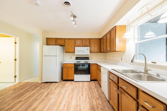8597 Mathias Dr Unit 42, Grosse Ile, MI 48138 - kitchen featuring white appliances, brown cabinetry, light wood-type flooring, and light countertops