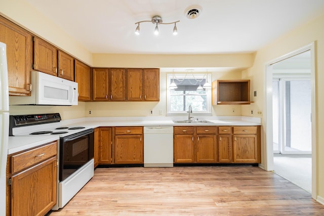 8597 Mathias Dr Unit 42, Grosse Ile, MI 48138 - kitchen with white appliances, brown cabinetry, light wood-type flooring, and light countertops