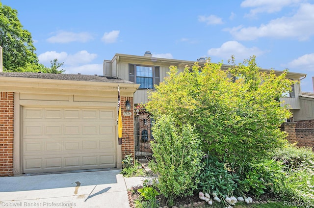7176 Nottingham, West Bloomfield, MI 48322 - view of front of home featuring brick siding, driveway, and a garage