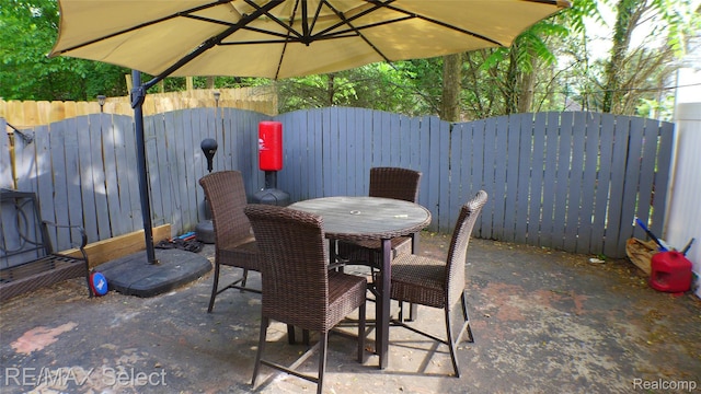 2633 Orchard Ln, Flint, MI 48504 - fenced backyard with outdoor dining space and a patio
