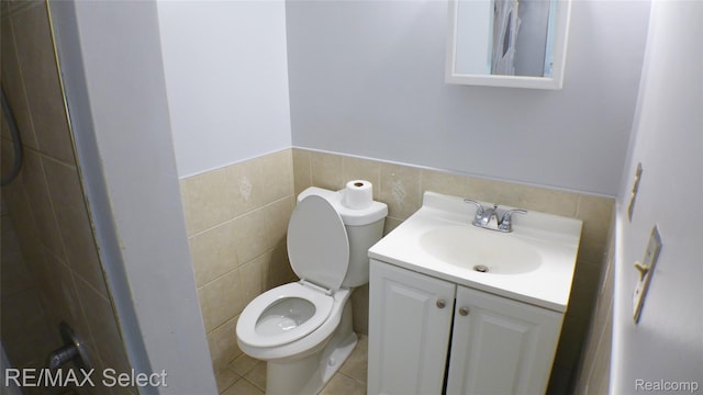 2633 Orchard Ln, Flint, MI 48504 - bathroom featuring tile walls, vanity, wainscoting, and tile patterned floors