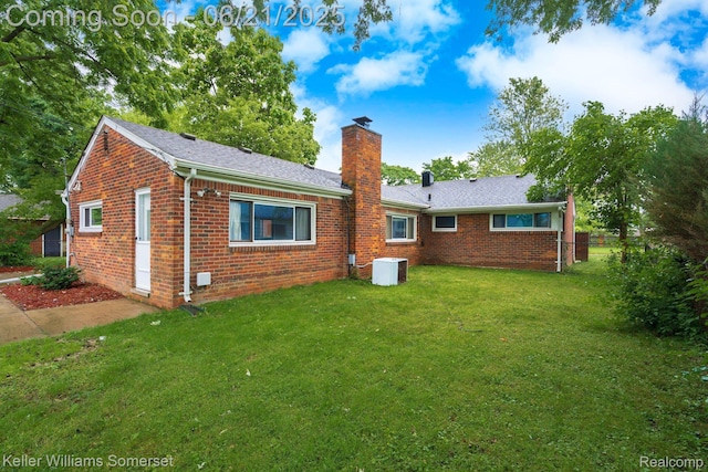 3620 Chester Rd, Royal Oak, MI 48073 - rear view of house with brick siding, a chimney, and a lawn