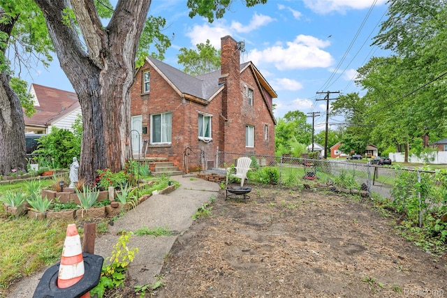 17304 Barlow St, Detroit, MI 48205 - rear view of house with brick siding, a chimney, and a fenced backyard