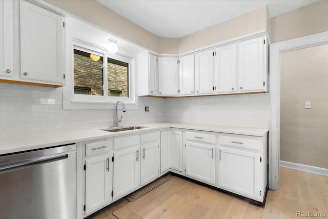 3225 Leslie St, Detroit, MI 48238 - kitchen featuring stainless steel dishwasher, backsplash, light countertops, and light wood-style flooring