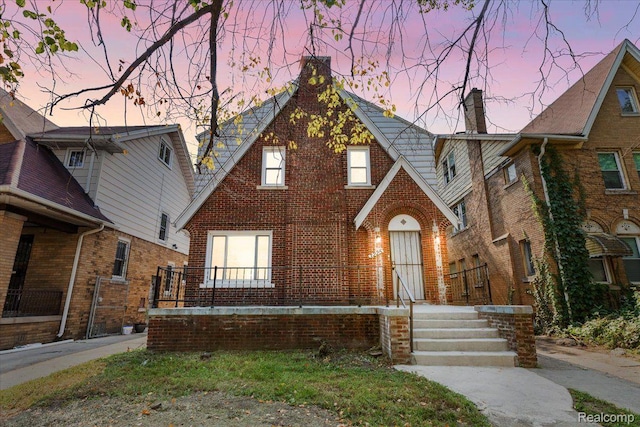 3225 Leslie St, Detroit, MI 48238 - tudor-style house with brick siding and a chimney