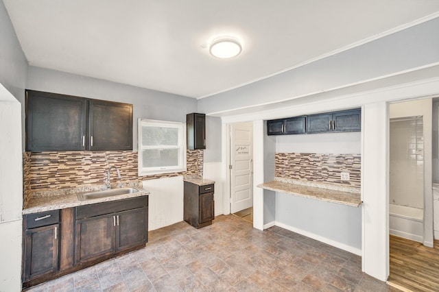 269 Euclid St, Mount Clemens, MI 48043 - kitchen featuring decorative backsplash, light countertops, and dark brown cabinetry