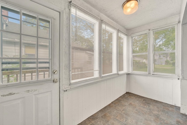 269 Euclid St, Mount Clemens, MI 48043 - unfurnished sunroom with stone finish flooring, healthy amount of natural light, and wooden walls