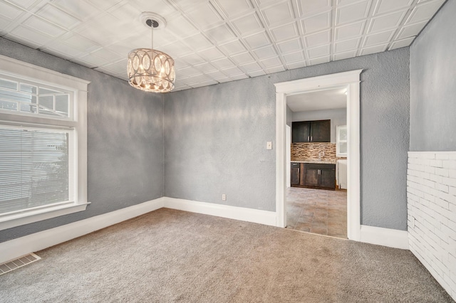 269 Euclid St, Mount Clemens, MI 48043 - empty room with carpet flooring and a chandelier