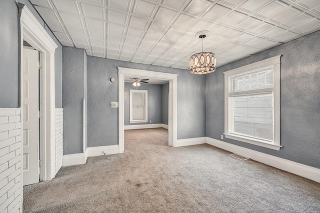 269 Euclid St, Mount Clemens, MI 48043 - carpeted empty room featuring a chandelier, a textured wall, and a ceiling fan