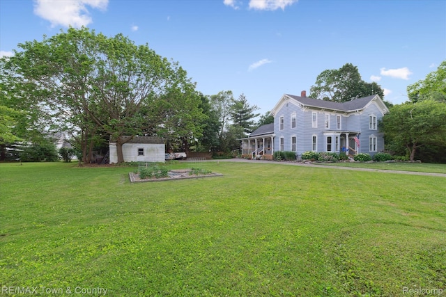 6501 River Rd, Flushing, MI 48433 - view of green lawn with a storage shed