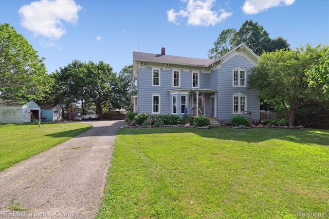 6501 River Rd, Flushing, MI 48433 - italianate house featuring a chimney and driveway