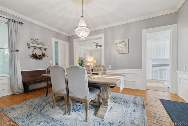 6501 River Rd, Flushing, MI 48433 - dining space featuring a chandelier, crown molding, light wood-type flooring, a ceiling fan, and wainscoting
