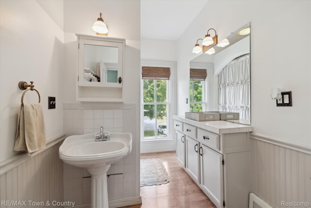 6501 River Rd, Flushing, MI 48433 - bathroom with a wainscoted wall and wood finished floors