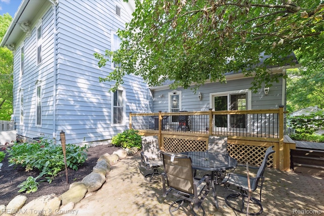 6501 River Rd, Flushing, MI 48433 - rear view of house with a deck and outdoor dining area