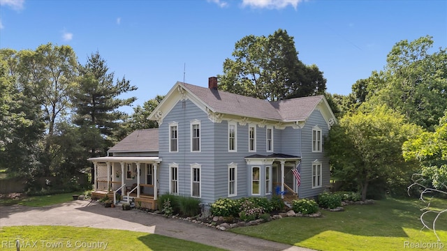 6501 River Rd, Flushing, MI 48433 - view of front of property featuring a chimney, a front lawn, covered porch, and a shingled roof