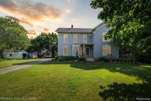 6501 River Rd, Flushing, MI 48433 - italianate-style house featuring a chimney and a yard