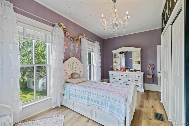 6501 River Rd, Flushing, MI 48433 - bedroom featuring a chandelier, light wood-style floors, and ornamental molding
