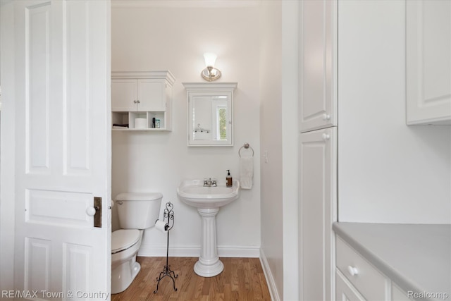 6501 River Rd, Flushing, MI 48433 - half bath with toilet and wood finished floors