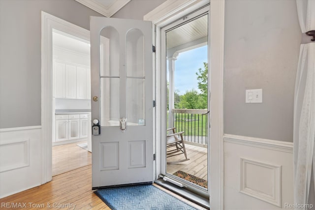 6501 River Rd, Flushing, MI 48433 - entryway featuring crown molding, wood finished floors, and a wainscoted wall