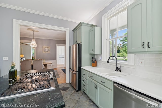 6501 River Rd, Flushing, MI 48433 - kitchen featuring stainless steel appliances, green cabinetry, crown molding, backsplash, and plenty of natural light