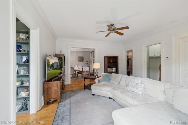 6501 River Rd, Flushing, MI 48433 - living room featuring light wood-style flooring, ceiling fan, and ornamental molding