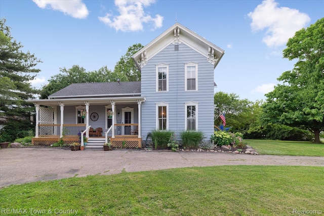 6501 River Rd, Flushing, MI 48433 - italianate house featuring a porch, a front lawn, and a shingled roof