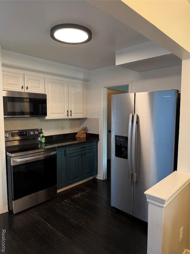 3355 Garden Ave, Royal Oak, MI 48073 - kitchen with appliances with stainless steel finishes, white cabinets, dark wood-style flooring, backsplash, and dark countertops