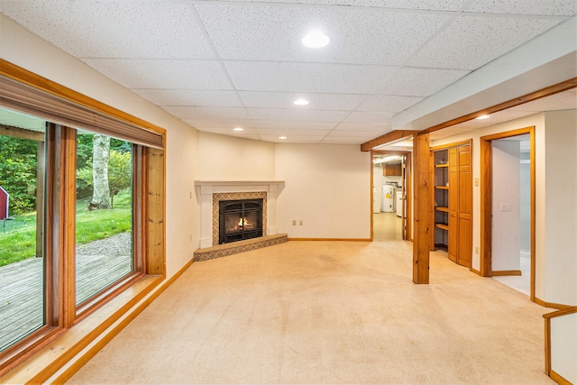 15770 157th Ave, Big Rapids, MI 49307 - unfurnished living room featuring light colored carpet, a drop ceiling, a glass covered fireplace, and recessed lighting