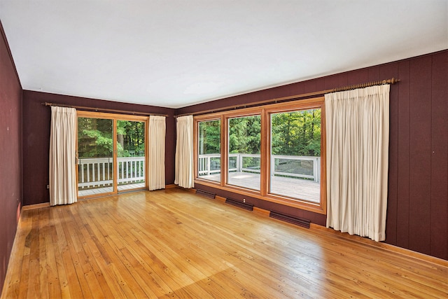 15770 157th Ave, Big Rapids, MI 49307 - empty room with light wood-type flooring and wooden walls