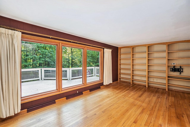 15770 157th Ave, Big Rapids, MI 49307 - spare room with light wood-style flooring and built in shelves
