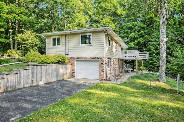 15770 157th Ave, Big Rapids, MI 49307 - view of front facade with asphalt driveway, brick siding, an attached garage, and a wooden deck